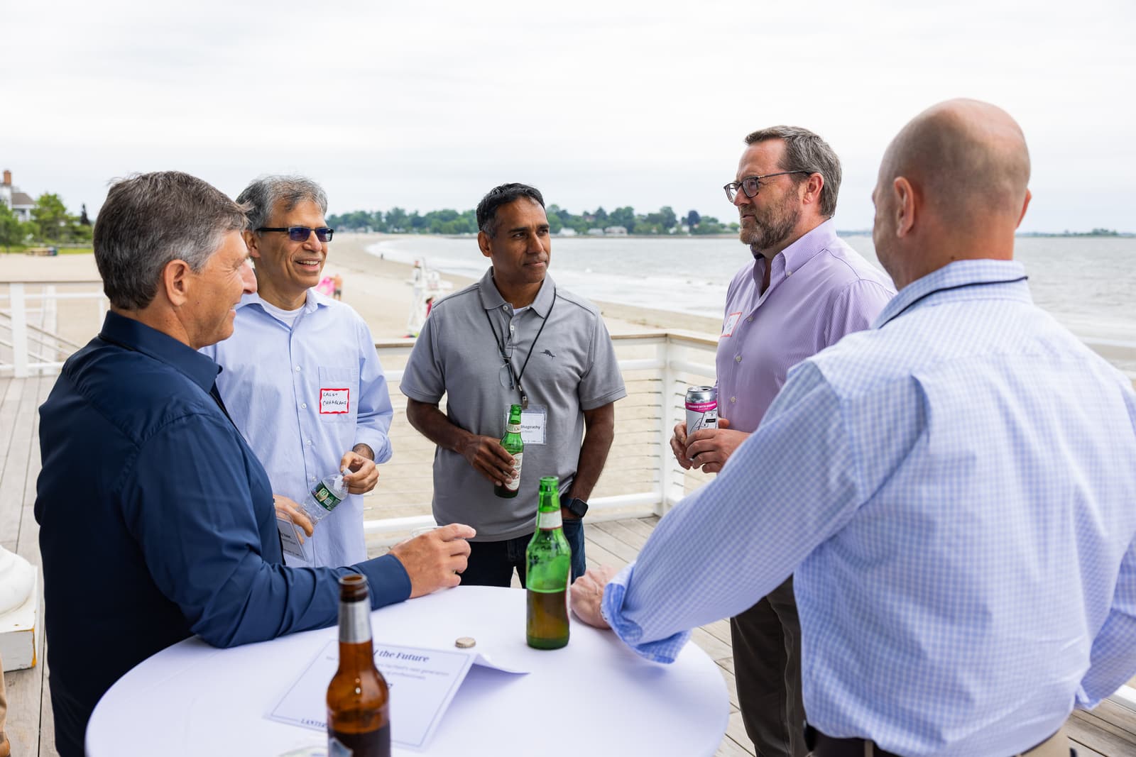 Industry advisors in conversation on the Penfield Pavilion deck by the water