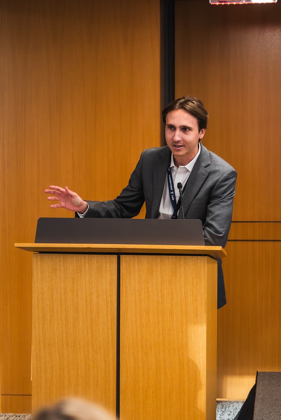 A young Associate speaks at the podium