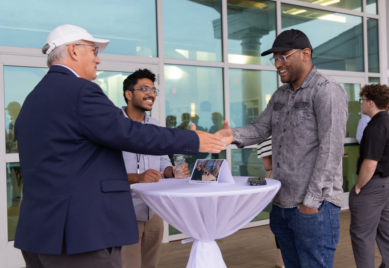 A young professional shakes hands with an industry advisor at an LPL event