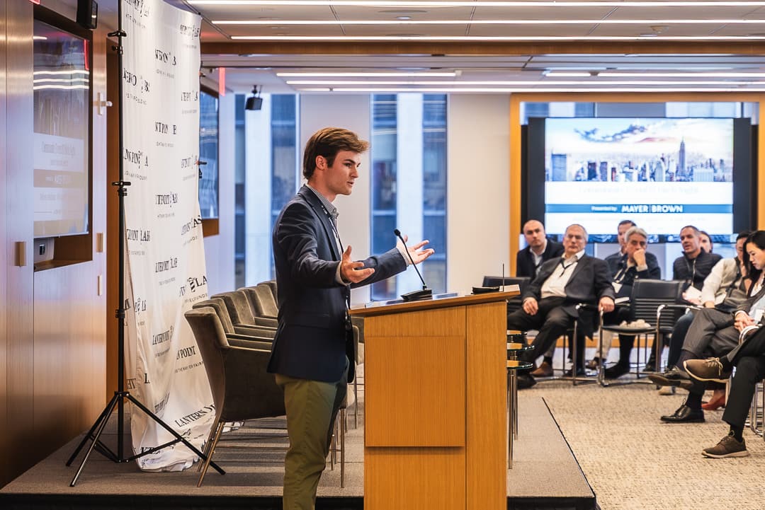 A speaker at the podium addresses the New York event
