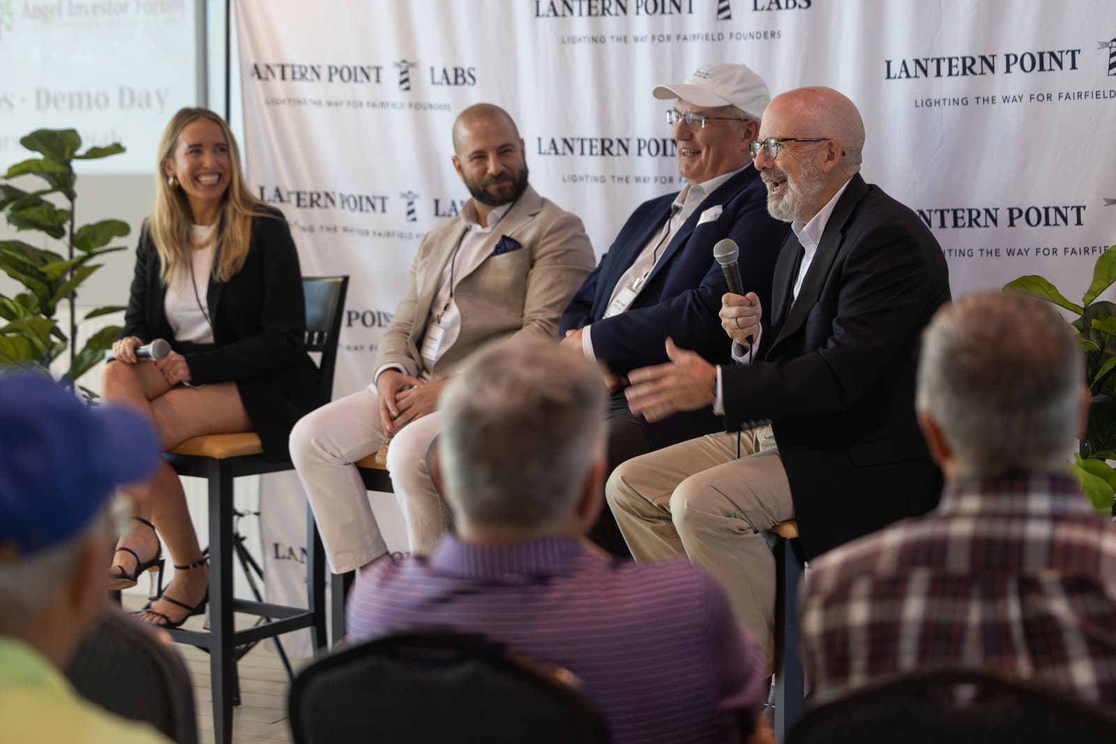 A panel of industry advisors speaks to the audience at an LPL event